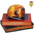 Carved Cat Curled on Book