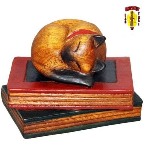 Carved Cat Curled on Book