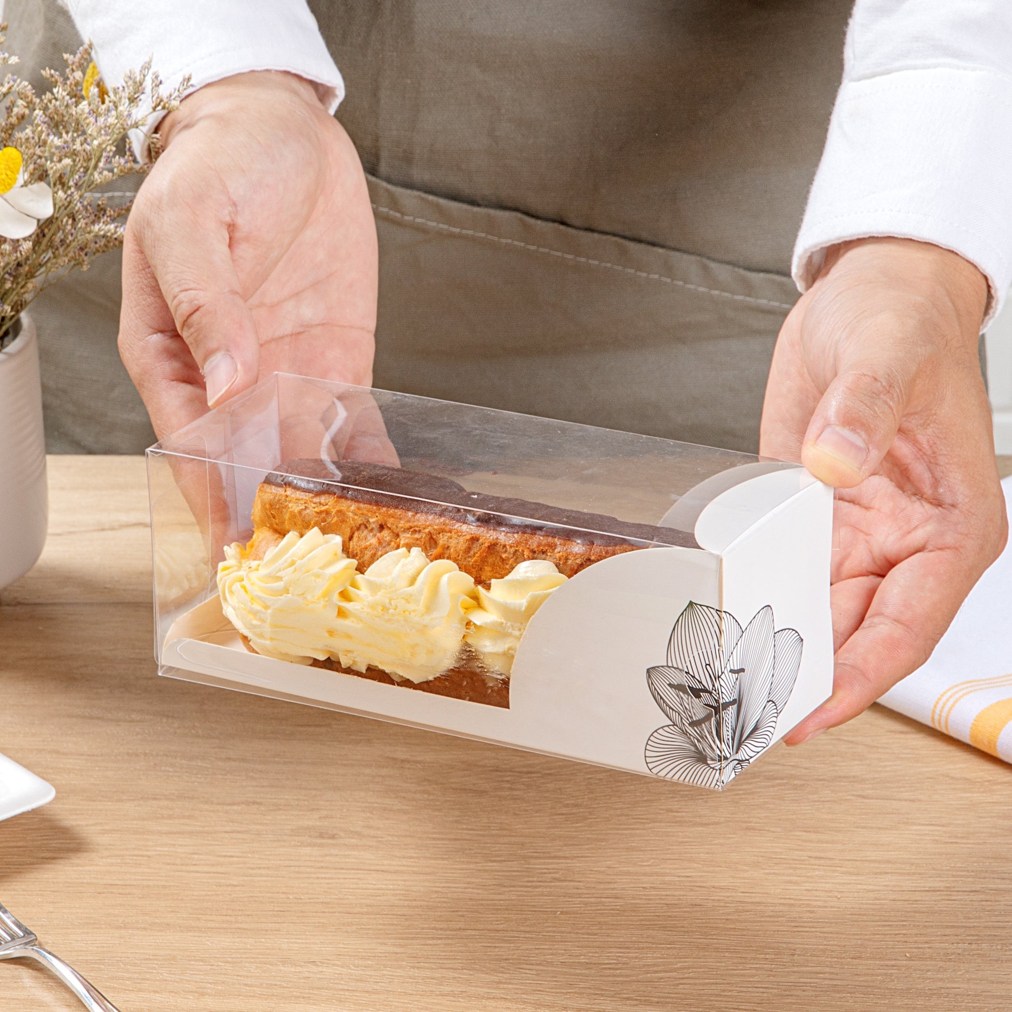 Sweet Vision Rectangle Clear Plastic Eclair Box - White Paper Sleeve, Lotus Accent - 7" x 2 1/2" x 2 1/2" - 100 count box