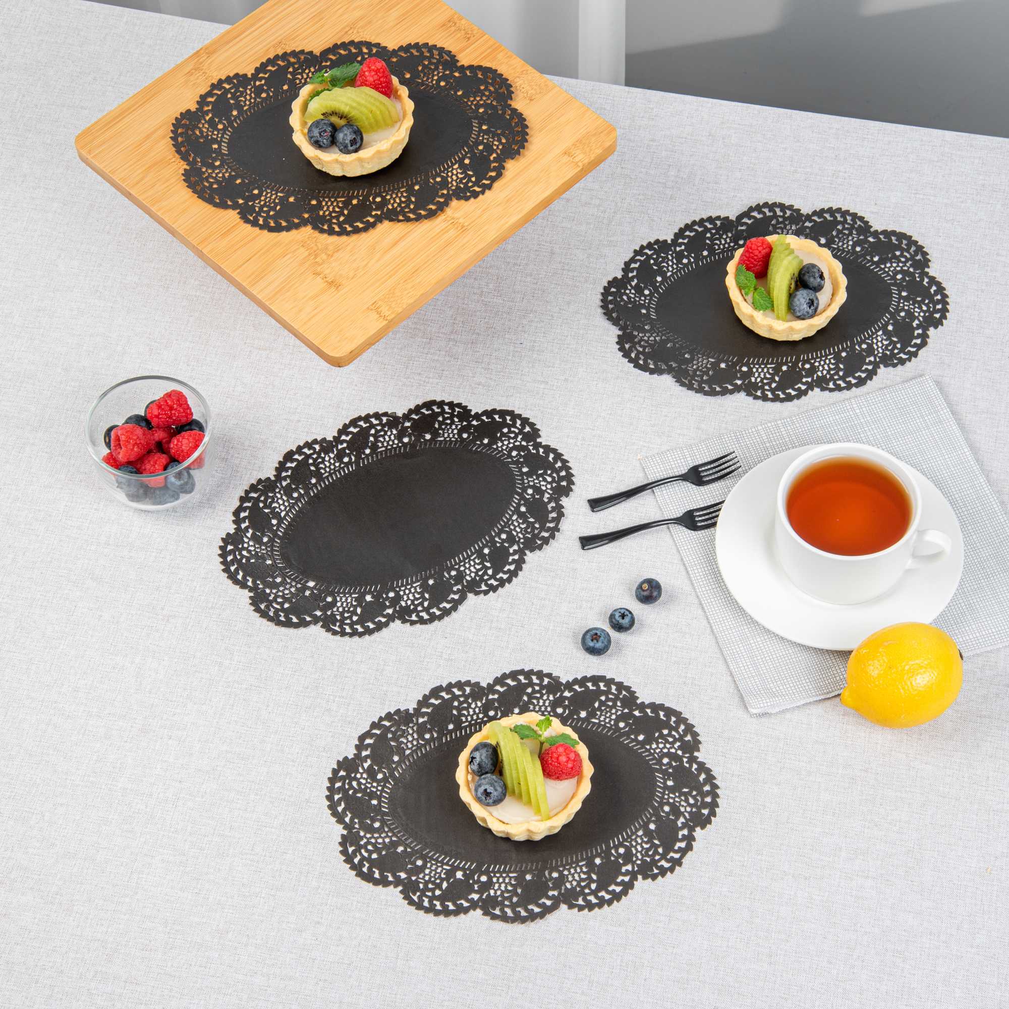 Pastry Tek Oval Black Paper Doilies - Lace - 9" x 6 1/2" - 100 count box