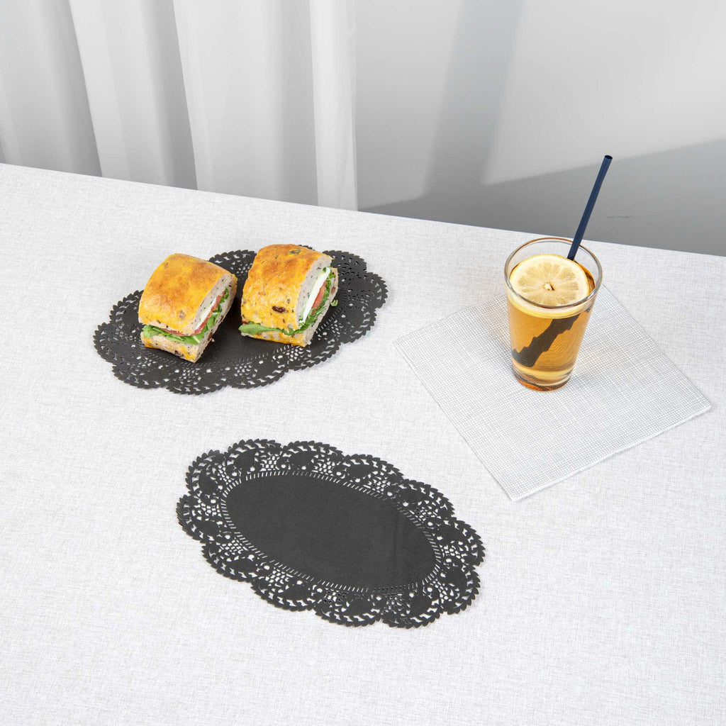 Pastry Tek Oval Black Paper Doilies - Lace - 10 1/2" x 6 1/2" - 100 count box
