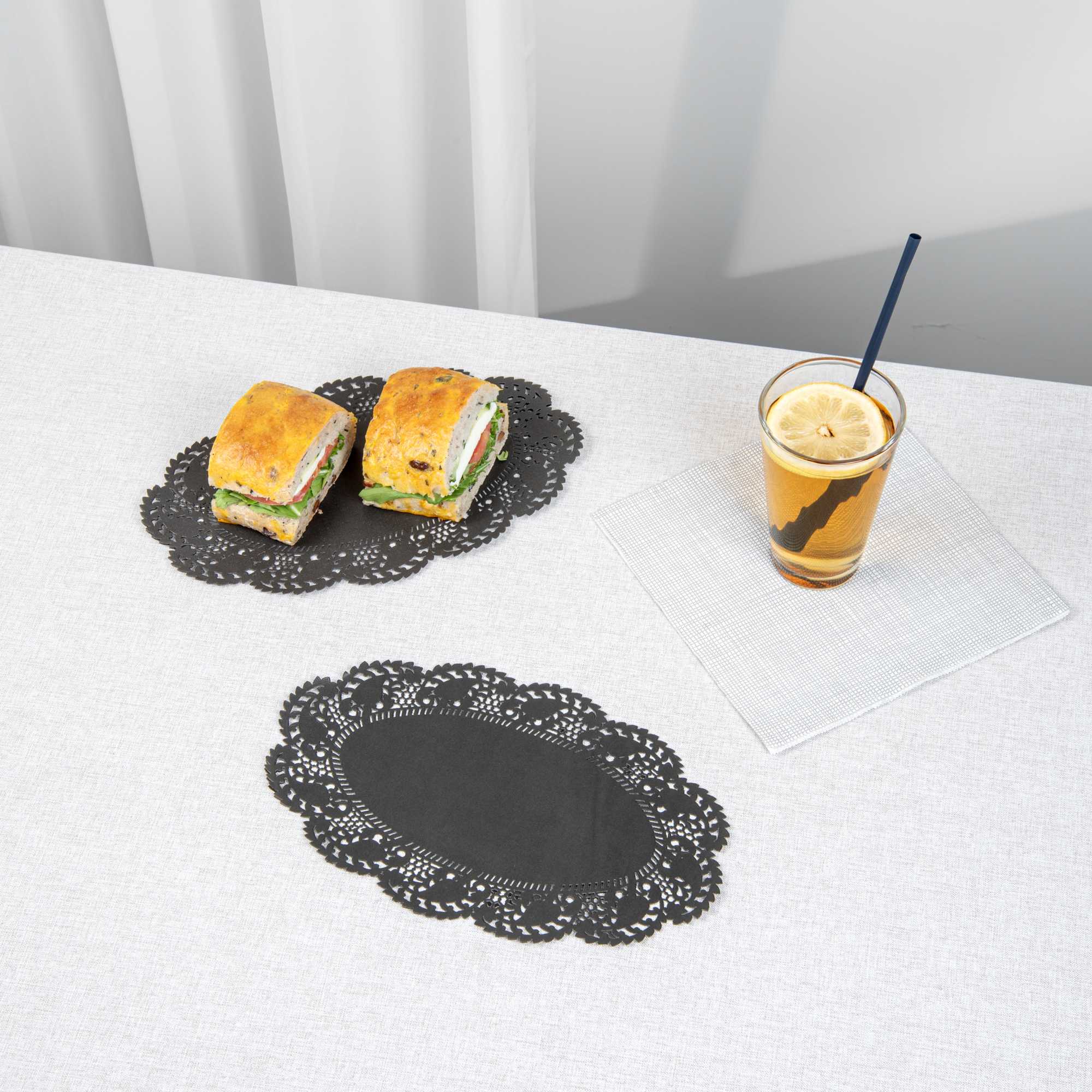 Pastry Tek Oval Black Paper Doilies - Lace - 10 1/2" x 6 1/2" - 100 count box