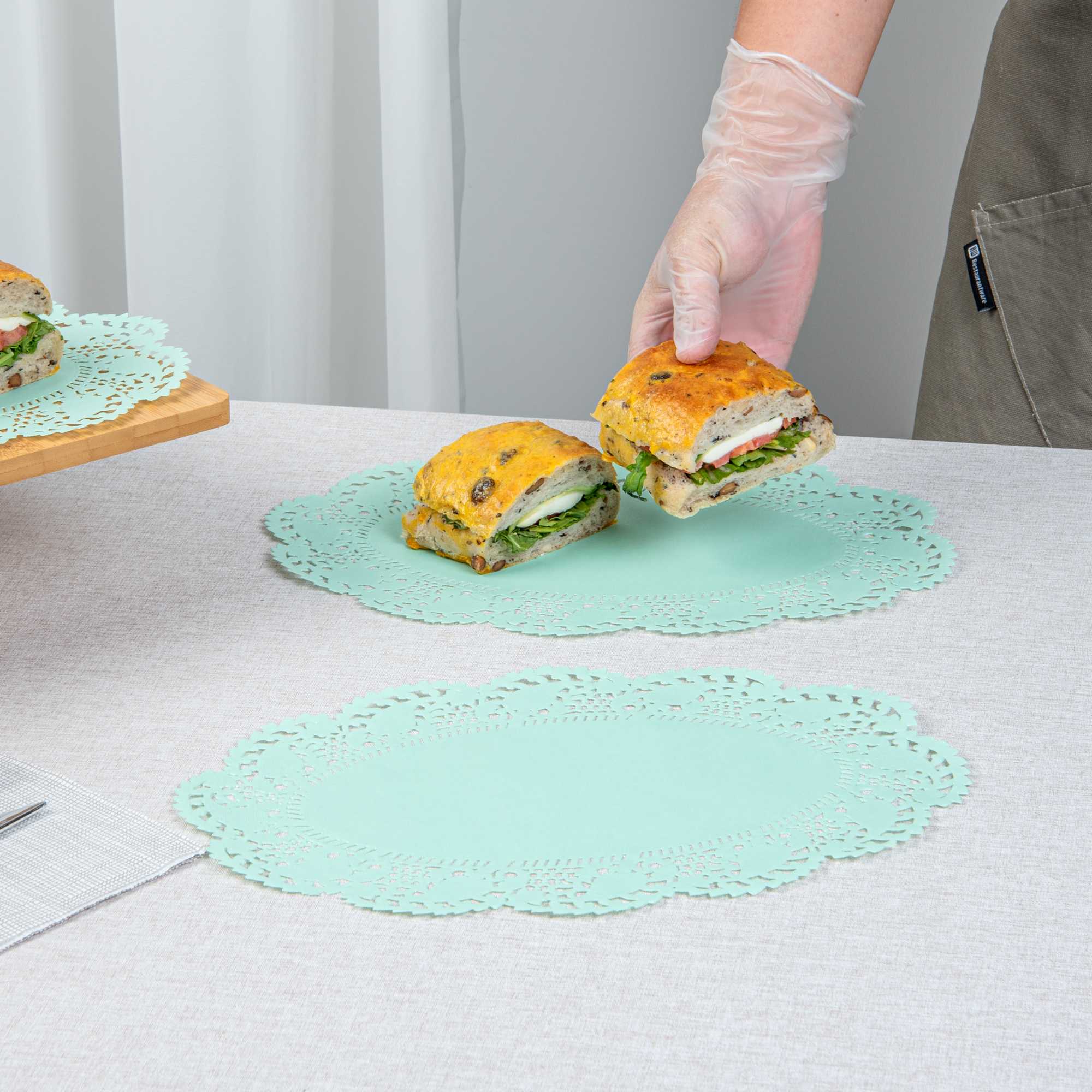 Pastry Tek Oval Teal Paper Doilies - Lace - 12 1/2" x 8 1/2" - 100 count box