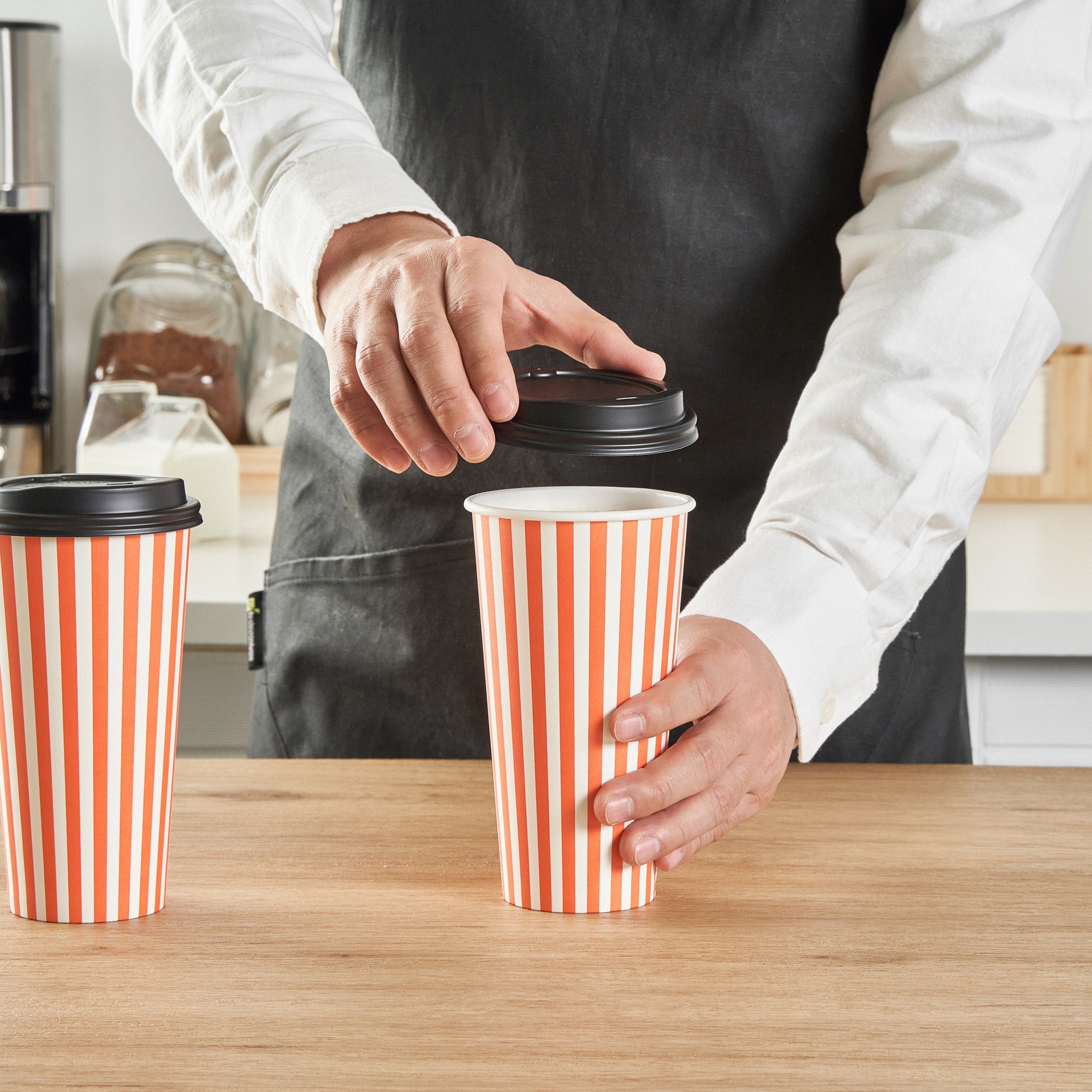 Restpresso 20 oz Orange and White Stripe Paper Single Wall Coffee Cup - with Black Lid - 3 1/2"x 3 1/2"x 6 1/4" - 20 count box