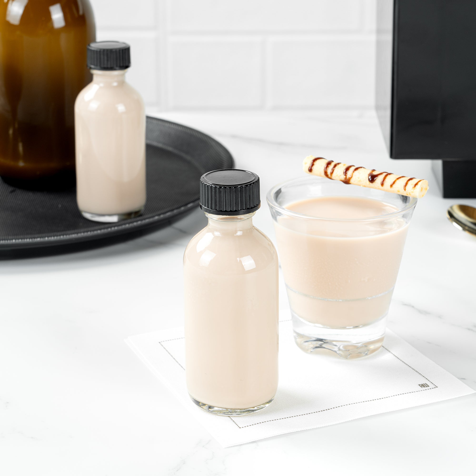 Vetri 2 oz Boston Round Clear Glass Bottle - with Black Phenolic Cap - 1 1/2" x 1 1/2" x 3 3/4" - 48 count box