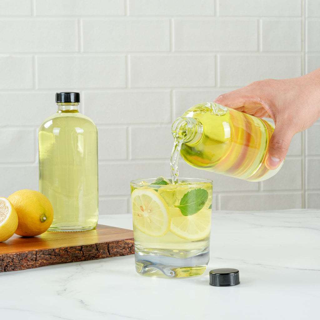 Vetri 16 oz Boston Round Clear Glass Bottle - with Black Phenolic Cap - 3" x 3" x 6 3/4" - 12 count box