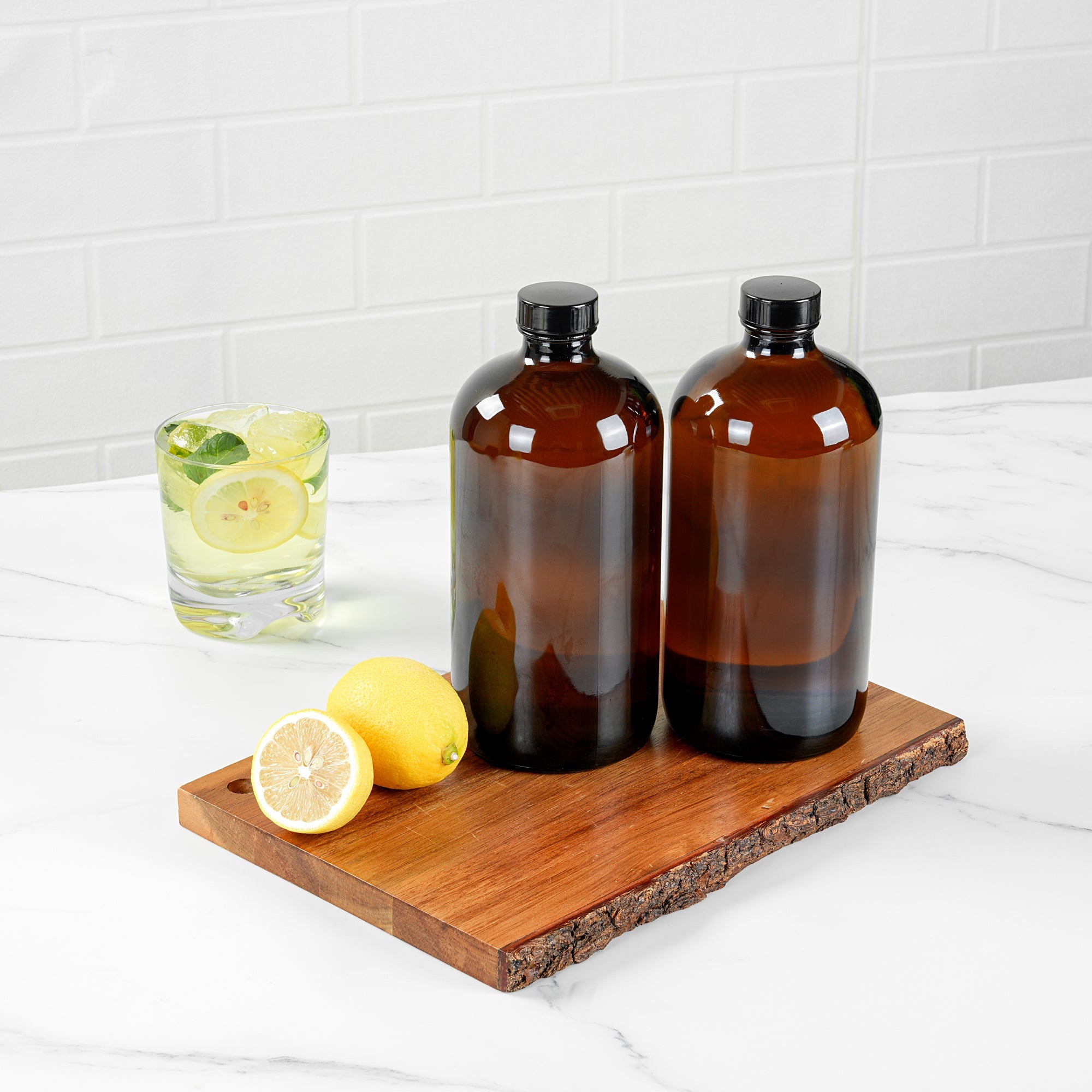 Vetri 32 oz Boston Round Amber Glass Bottle - with Black Phenolic Cap - 3 3/4" x 3 3/4" x 8" - 12 count box