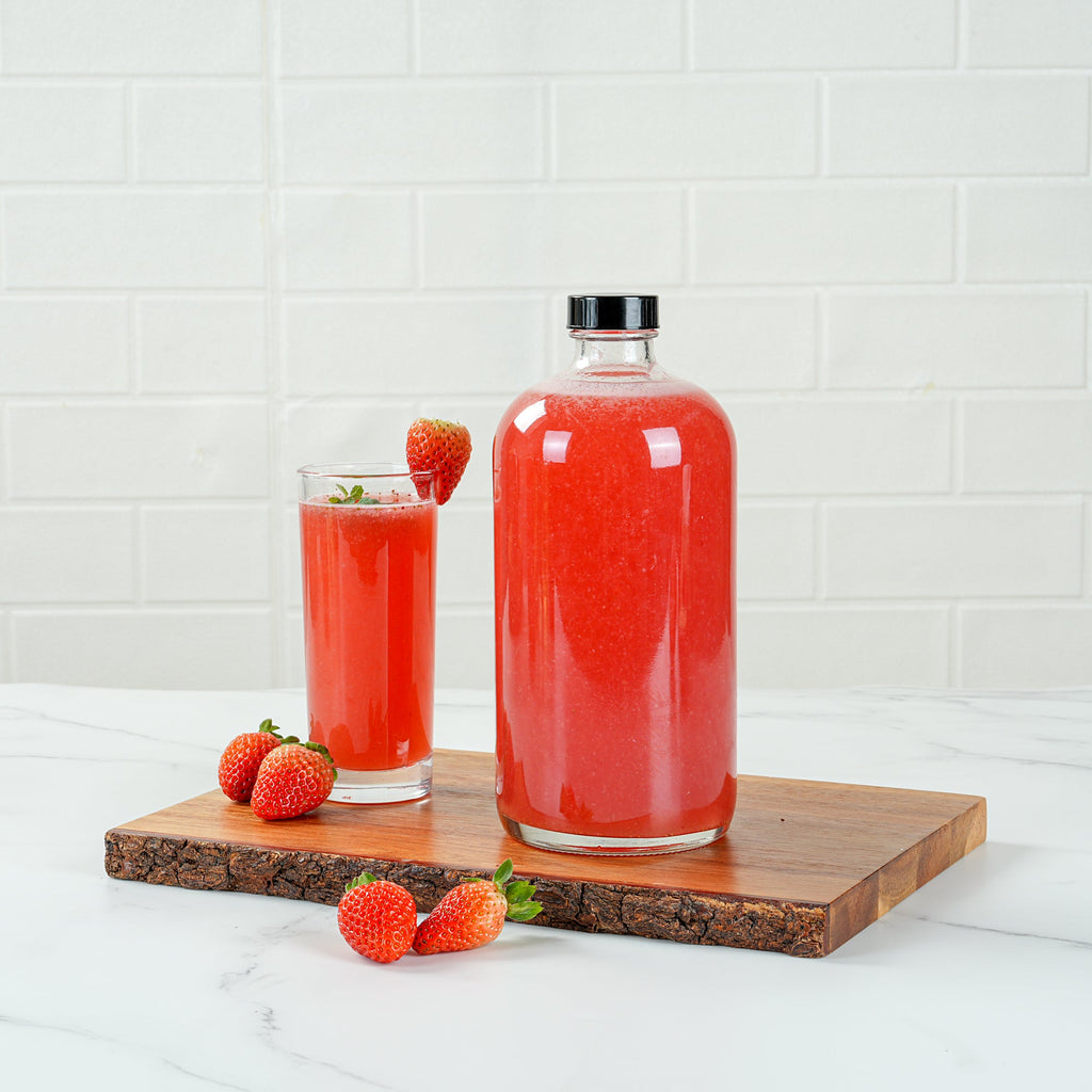 Vetri 32 oz Boston Round Clear Glass Bottle - with Black Phenolic Cap - 3 3/4" x 3 3/4" x 8" - 12 count box