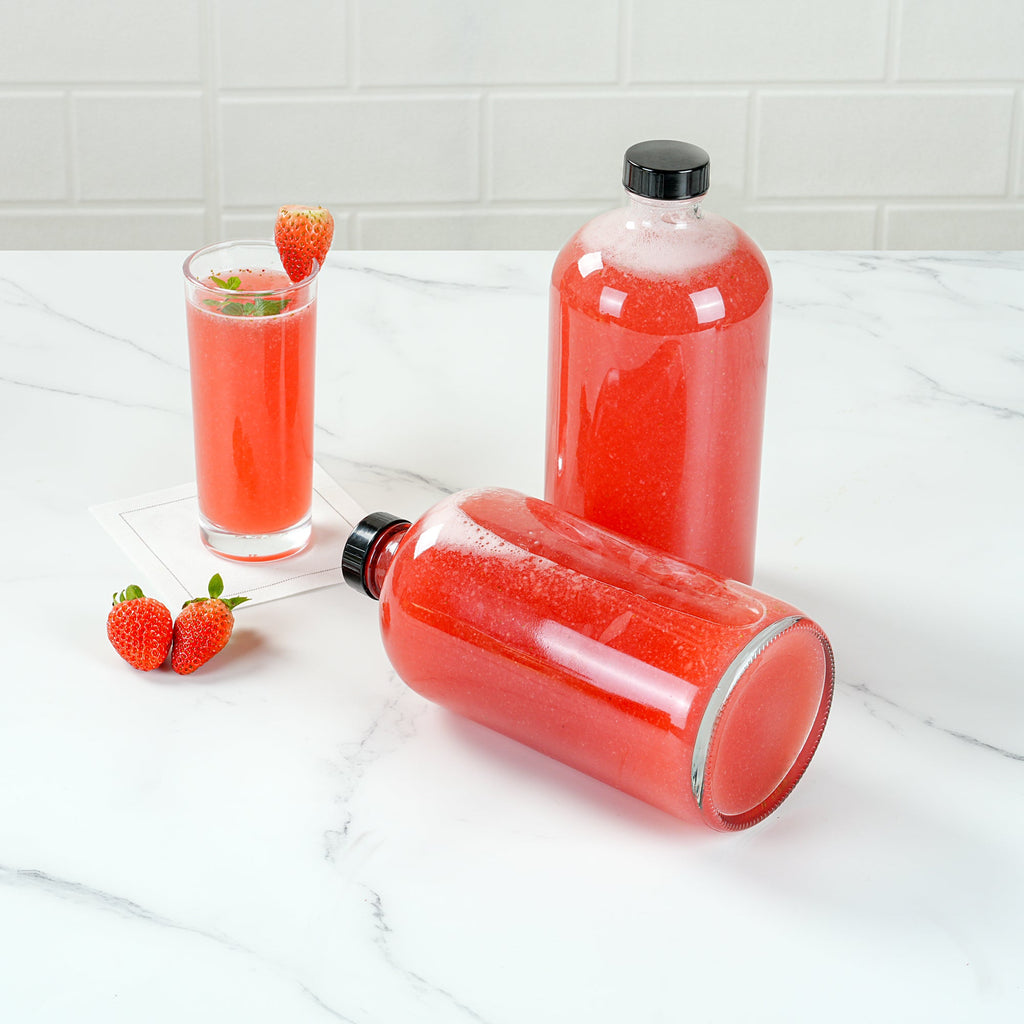 Vetri 32 oz Boston Round Clear Glass Bottle - with Black Phenolic Cap - 3 3/4" x 3 3/4" x 8" - 12 count box