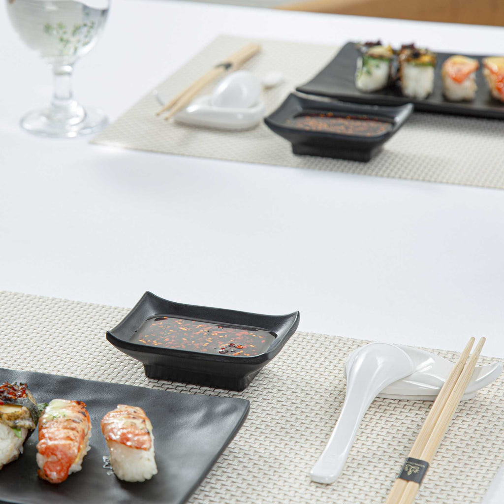 Voga 1 oz Rectangle Black Melamine Sauce Dish - Japonais - 4" x 2 1/2" x 1 1/4" - 10 count box