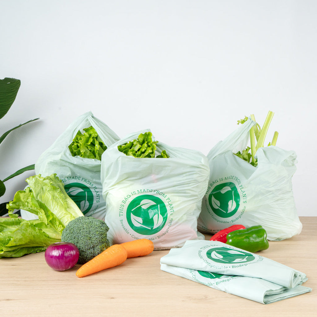 Basic Nature Green Plastic T-Shirt Bag - 1/6 Size, Compostable - 12" x 6 1/2" x 22" - 100 count box