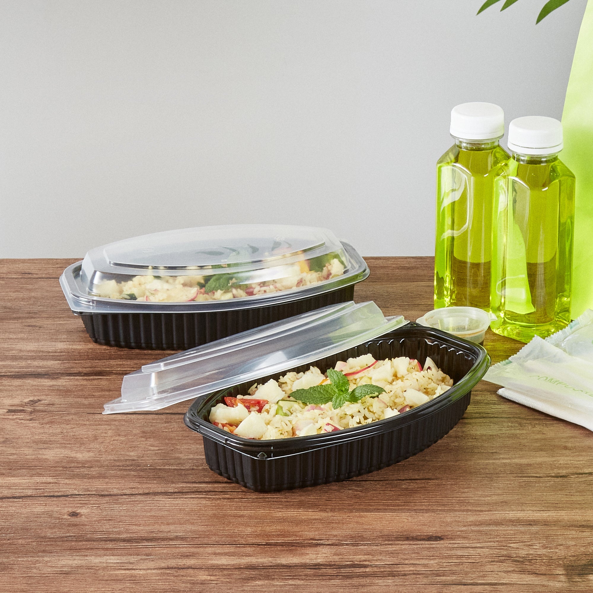 Chef 101 24 oz Oval Black Plastic Food Container - with Clear Lid, Microwavable - 9 1/4" x 5 3/4" x 2 1/2" - 50 count box