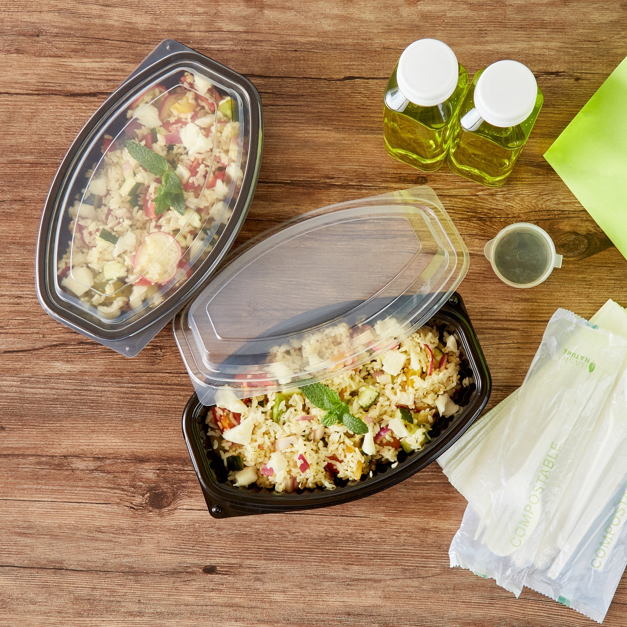 Chef 101 24 oz Oval Black Plastic Food Container - with Clear Lid, Microwavable - 9 1/4" x 5 3/4" x 2 1/2" - 50 count box