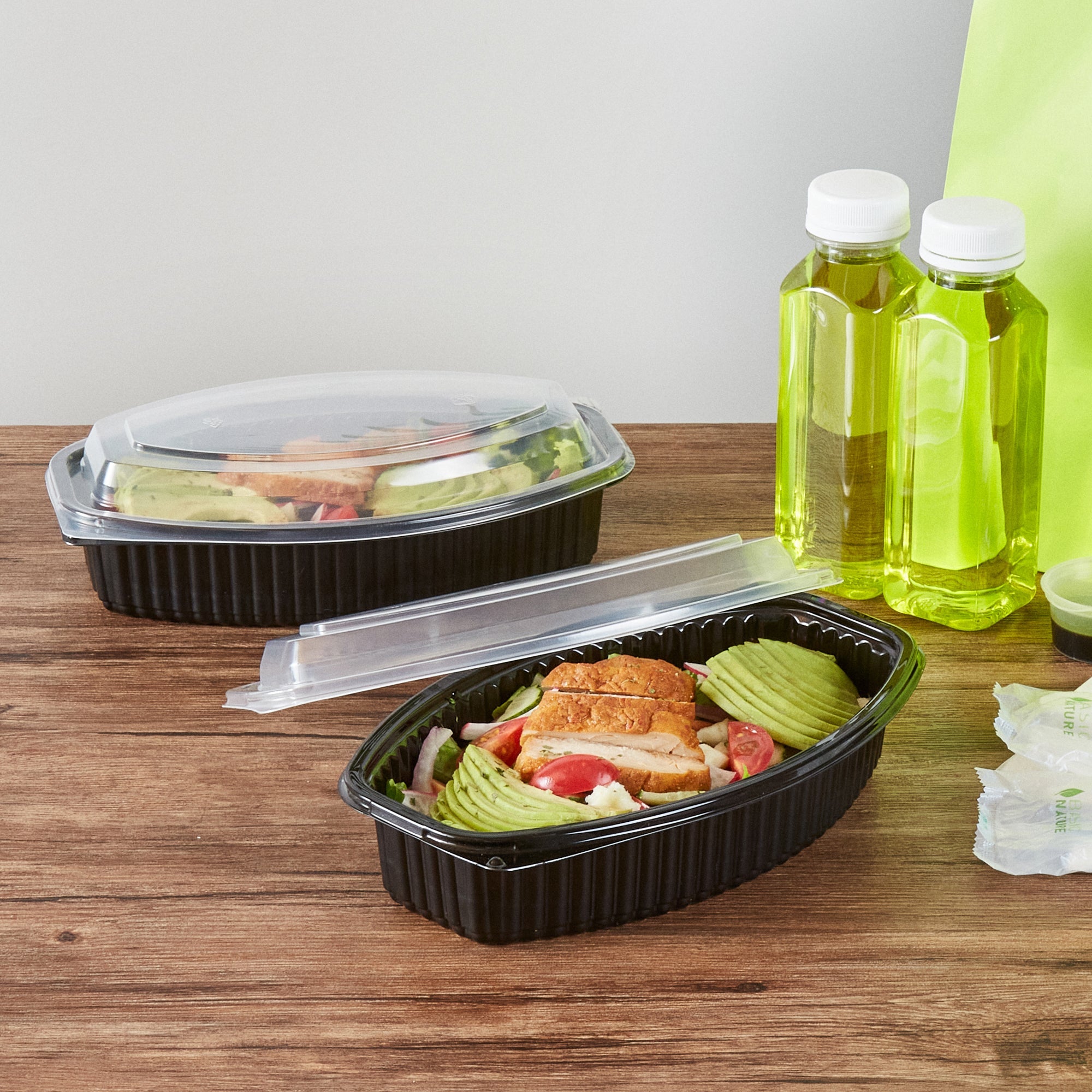 Chef 101 28 oz Oval Black Plastic Food Container - with Clear Lid, Microwavable - 9 1/4" x 5 3/4" x 2 3/4" - 100 count box