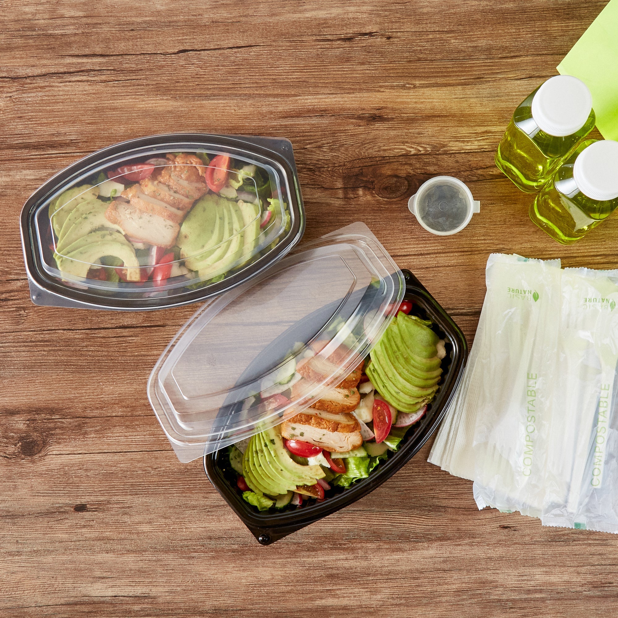 Chef 101 28 oz Oval Black Plastic Food Container - with Clear Lid, Microwavable - 9 1/4" x 5 3/4" x 2 3/4" - 100 count box