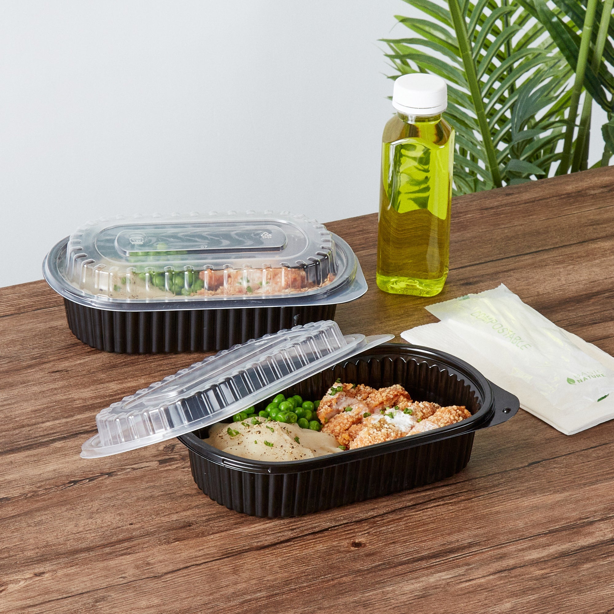 Chef 101 32 oz Oval Black Plastic Food Container - with Clear Dome Lid, Microwavable - 9 1/4" x 6" x 2 1/2" - 50 count box