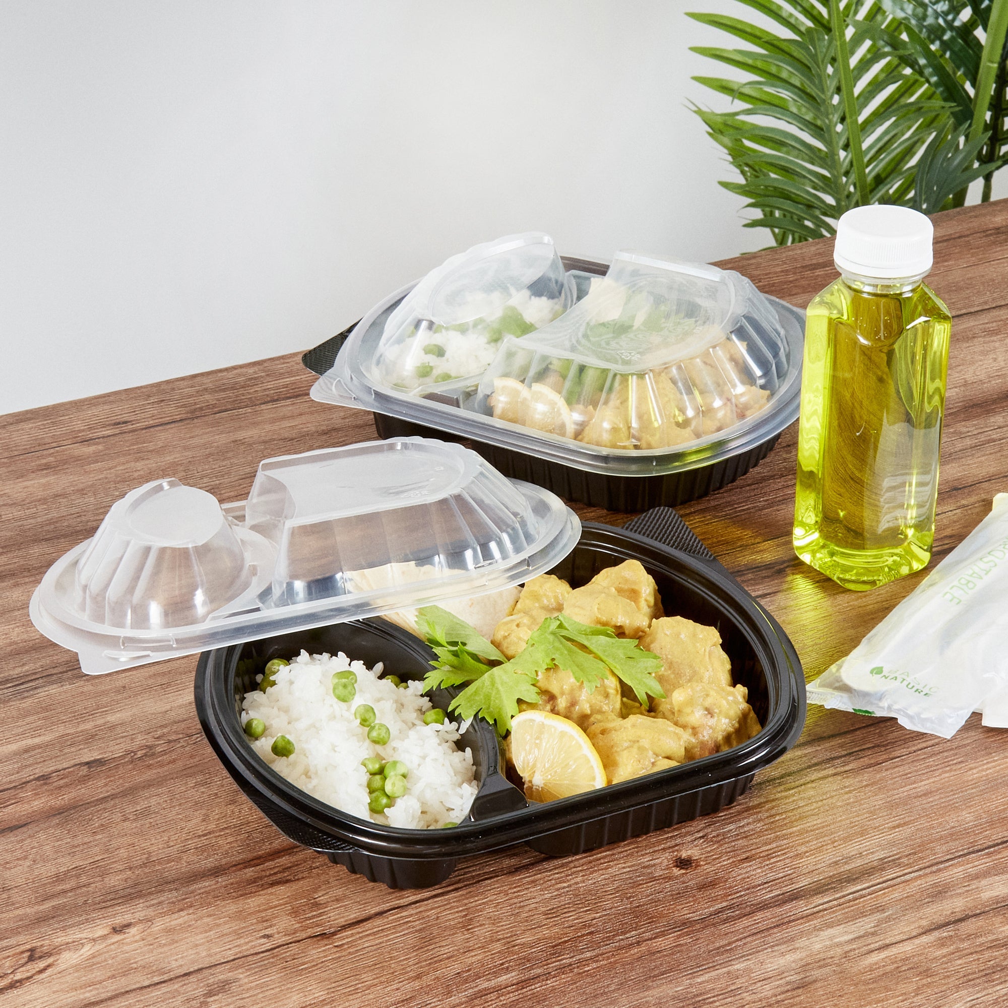 Chef 101 28 oz Oval Black Plastic Food Container - with Clear Lid, 2 Compartments, Microwavable - 9 1/2" x 8" x 2 3/4" - 50 count box