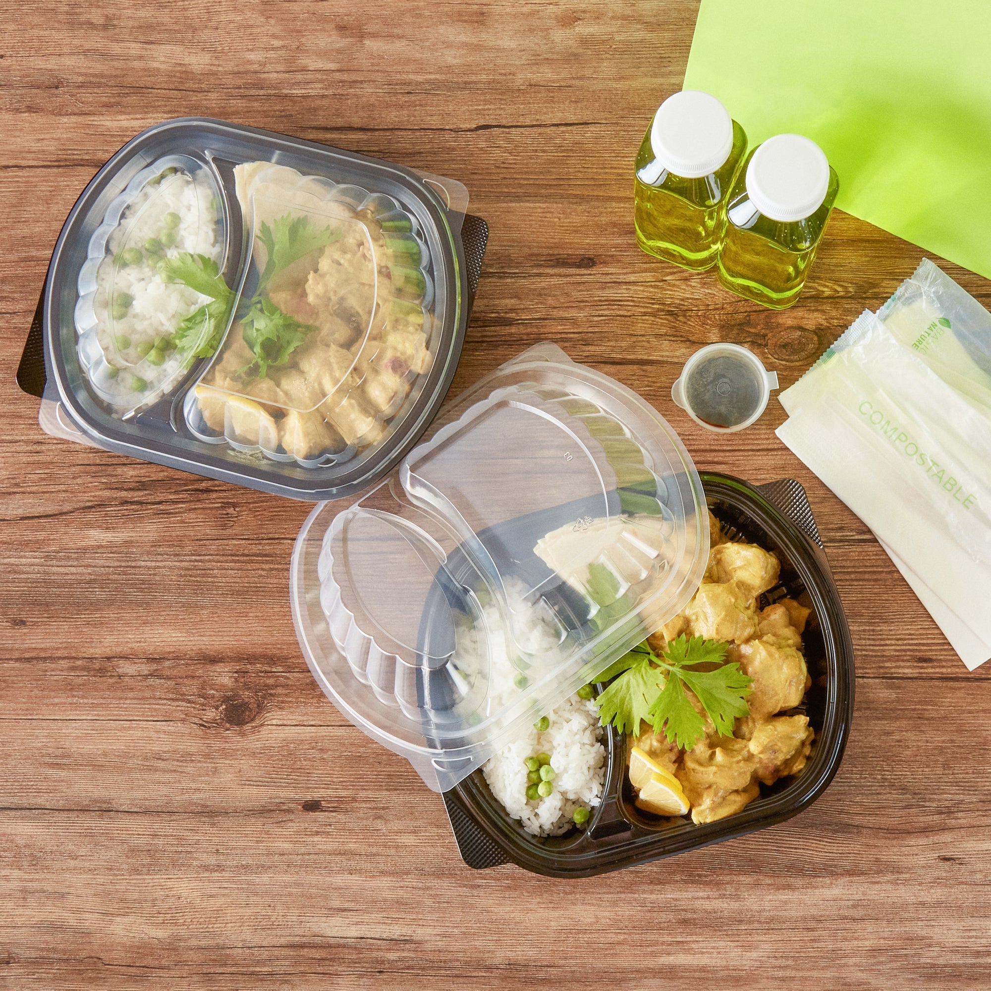 Chef 101 28 oz Oval Black Plastic Food Container - with Clear Lid, 2 Compartments, Microwavable - 9 1/2" x 8" x 2 3/4" - 50 count box