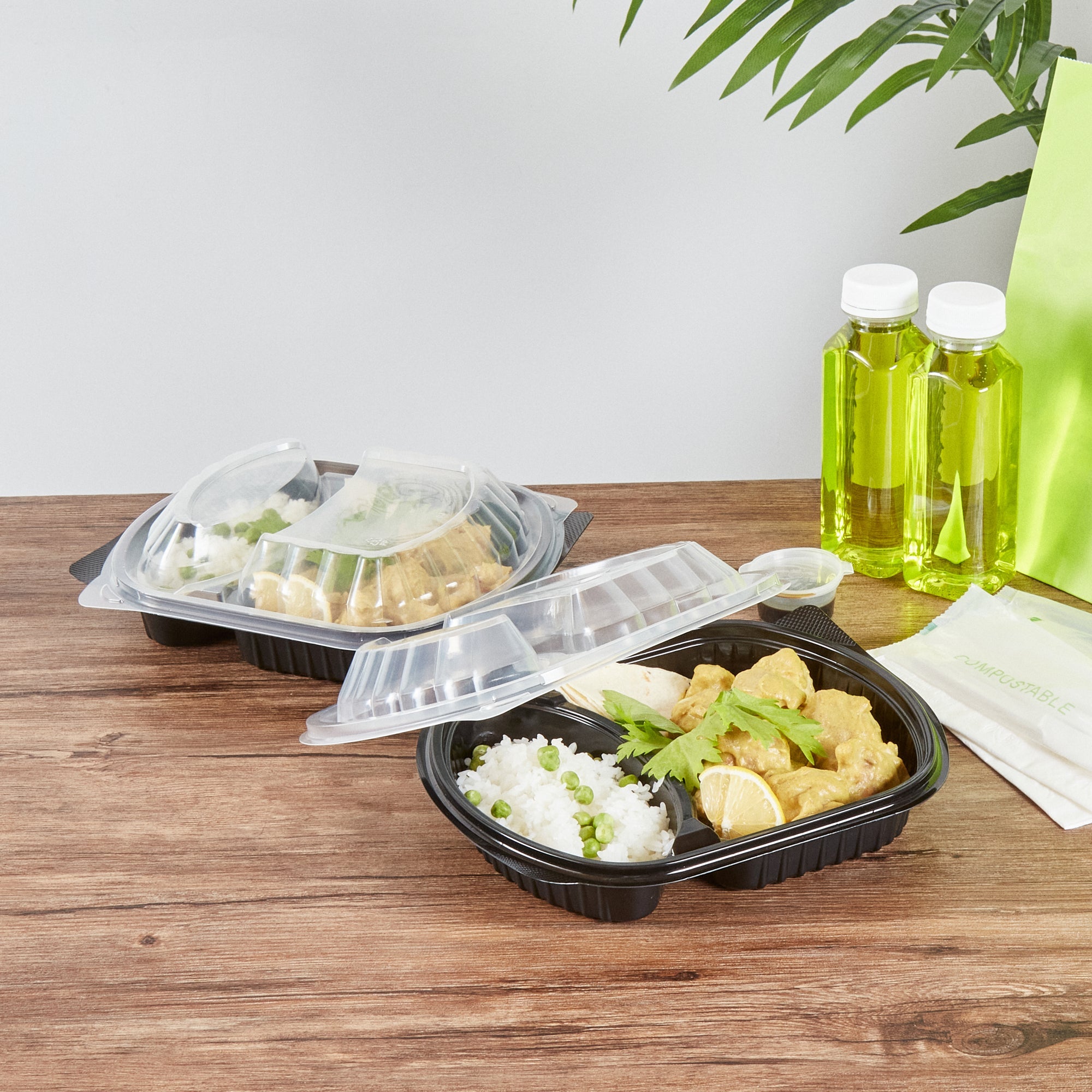 Chef 101 28 oz Oval Black Plastic Food Container - with Clear Lid, 2 Compartments, Microwavable - 9 1/2" x 8" x 2 3/4" - 100 count box