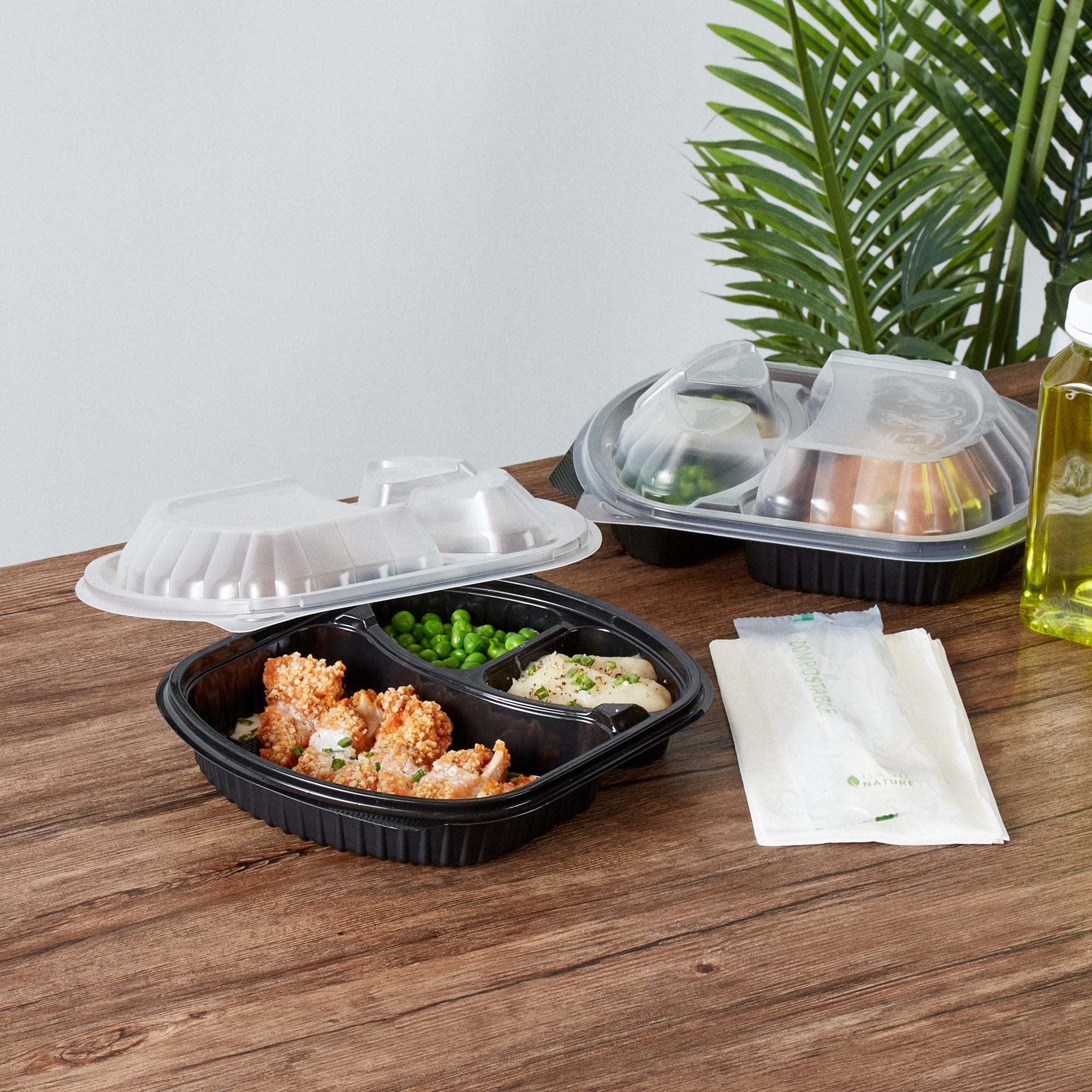 Chef 101 27 oz Oval Black Plastic Food Container - with Clear Lid, 3 Compartments, Microwavable - 9 1/2" x 8" x 2 3/4" - 100 count box