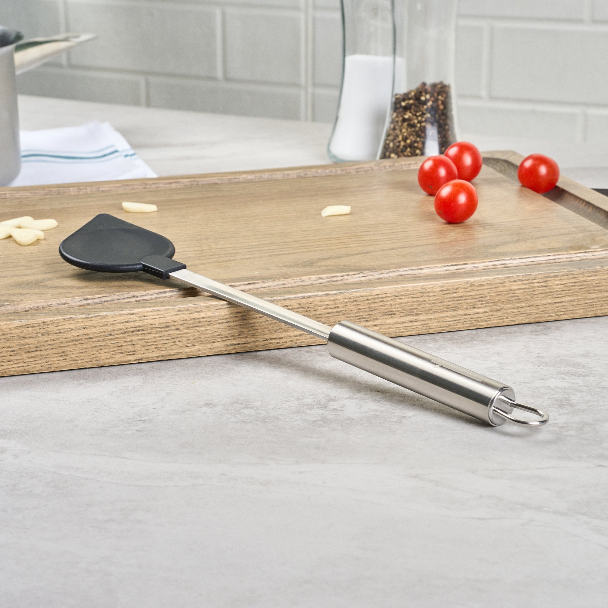 German Standard Black Nylon High Heat Cooking Spoon - Pointed Tip, with Stainless Steel Handle - 12 3/4'' x 2 1/4'' - 1 count box