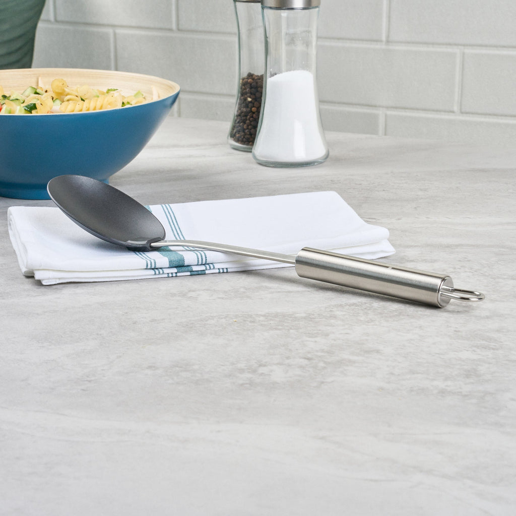 German Standard Black Nylon High Heat Solid Serving Spoon - with Stainless Steel Handle - 12 1/2'' x 2 1/2'' x 1 1/2'' - 1 count box