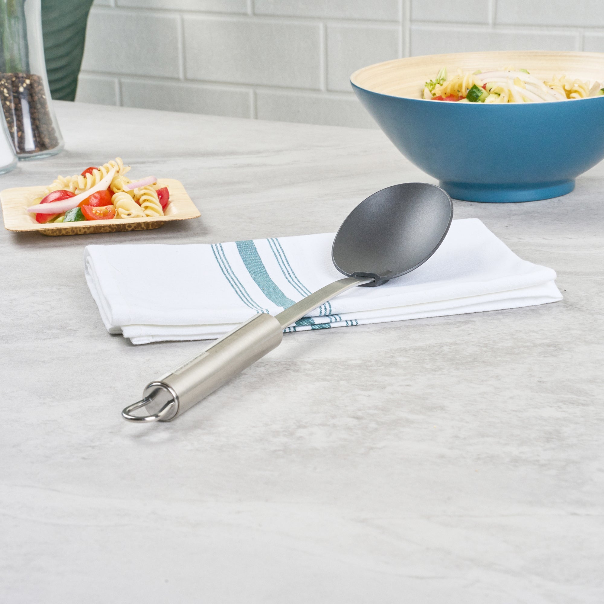 German Standard Black Nylon High Heat Solid Serving Spoon - with Stainless Steel Handle - 12 1/2'' x 2 1/2'' x 1 1/2'' - 1 count box