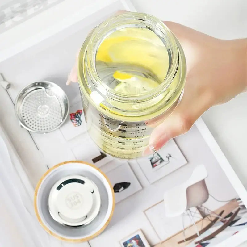 Modern glass water bottle with wood lid and tea filter kitchen accessory