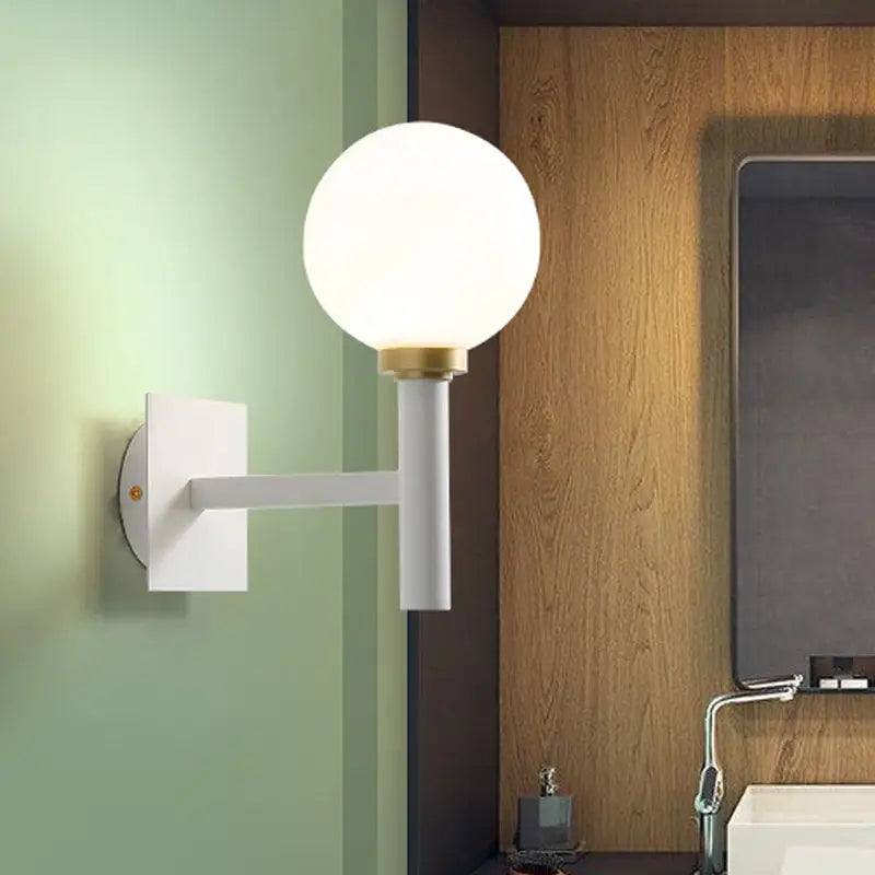 Minimalist white and brass wall lamp with opal glass shade bedroom