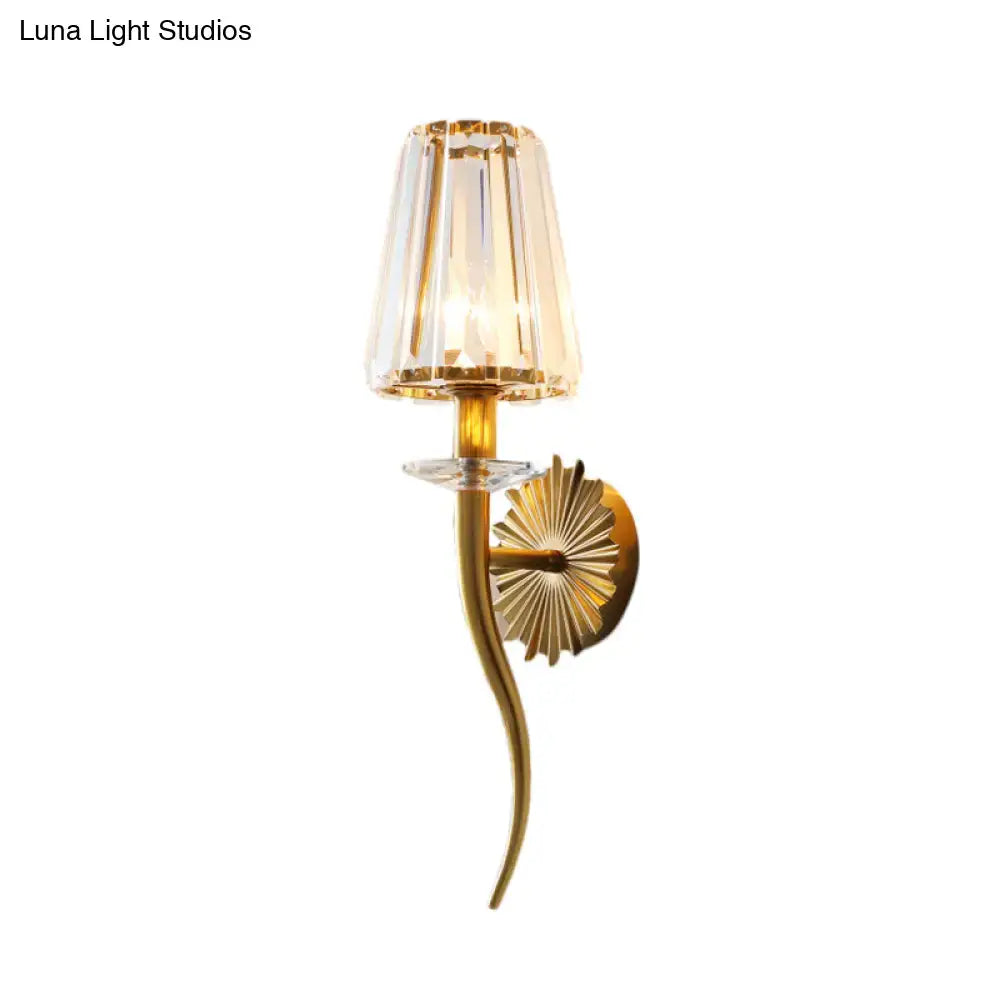 Modern gold wall light with clear tapered shade for stairways