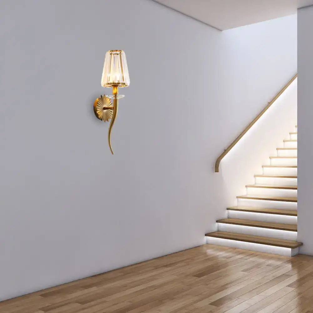 Modern gold wall light with clear tapered shade for stairways
