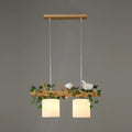 Rustic wood island light with maple leaf plant birds dining room